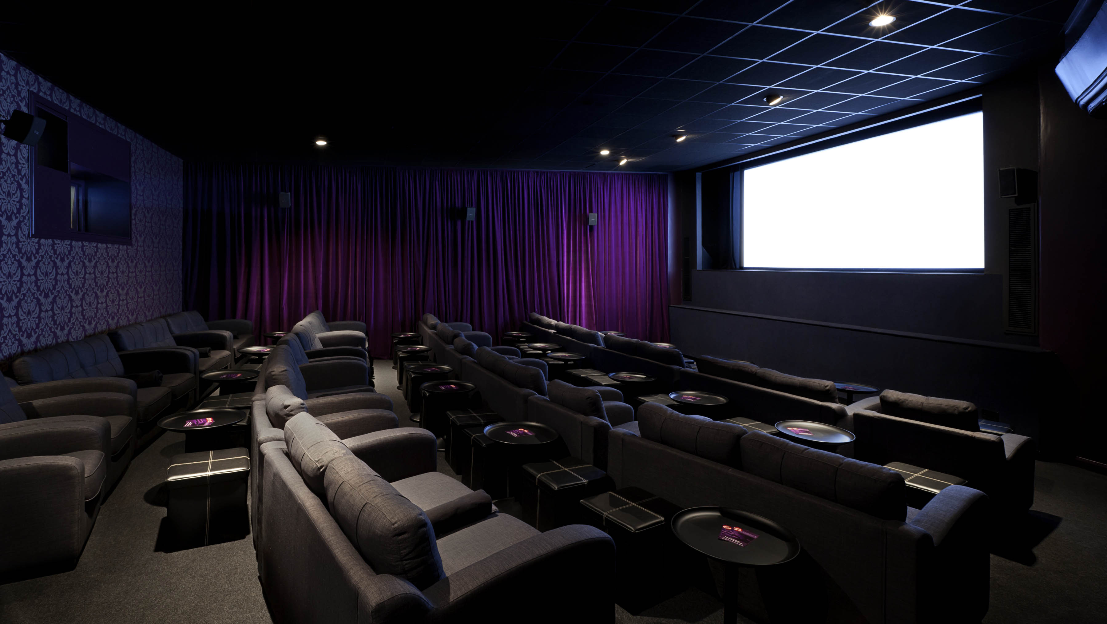 Modern screening room with plush seating for private events at Genesis Cinema.