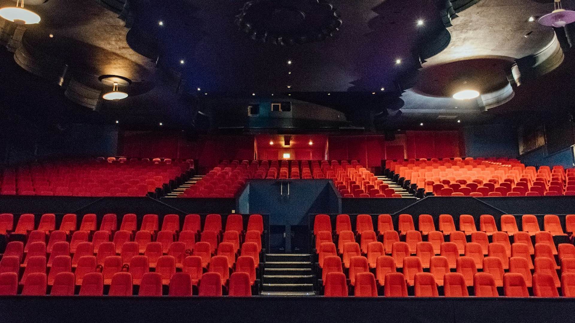 Studio 5 at Genesis Cinema with vibrant red seating, perfect for events and screenings.