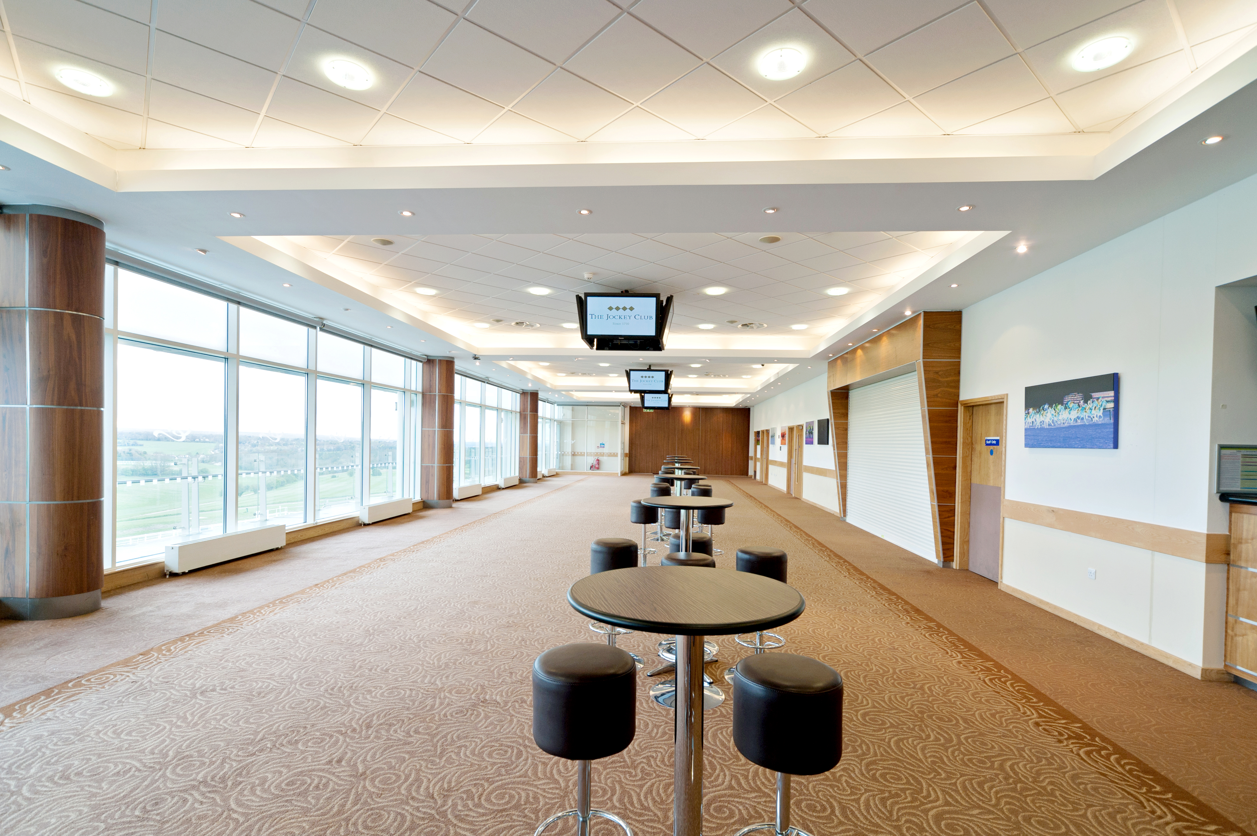 Lammtarra Suite at Epsom Downs: modern event venue with large windows for networking.